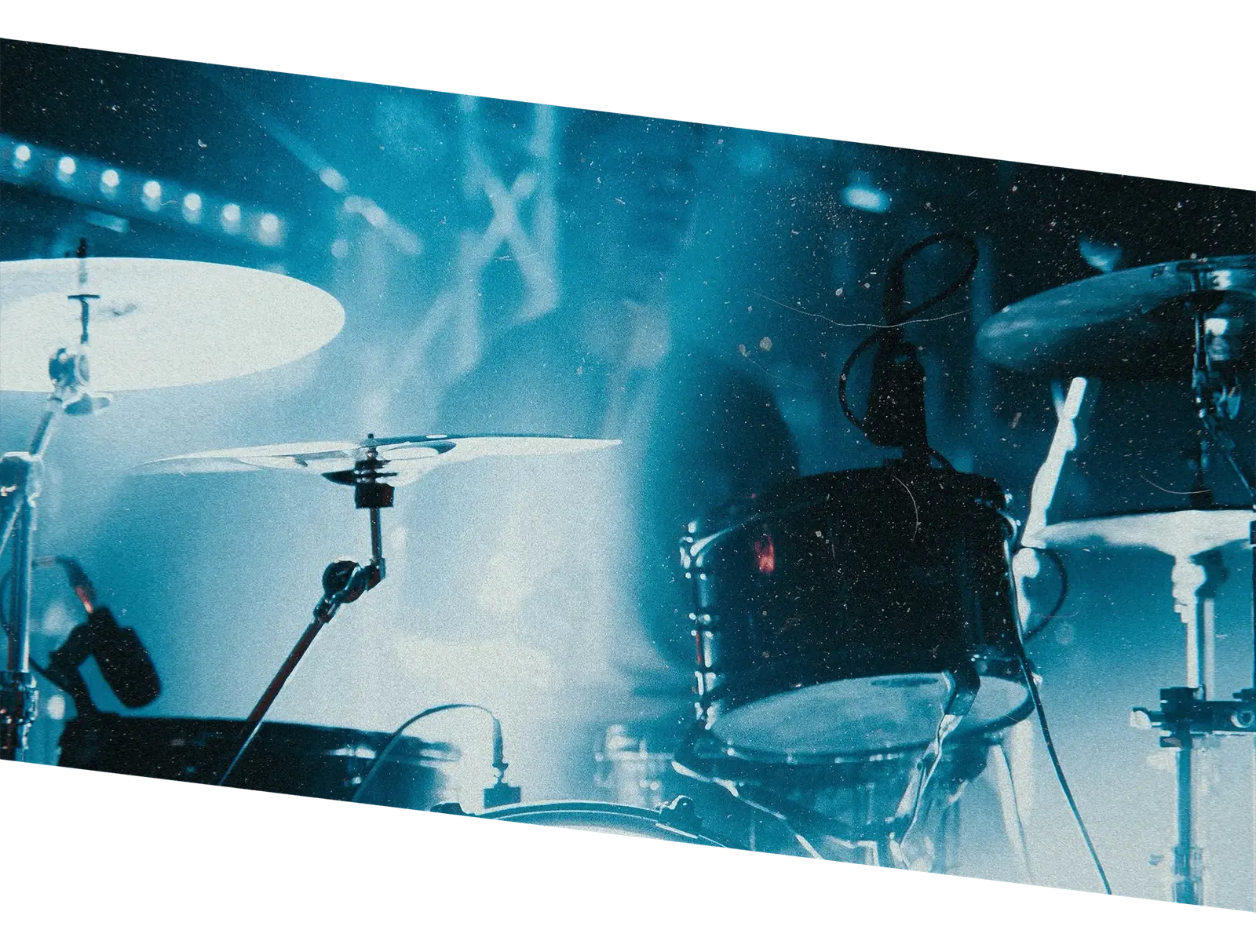 Band performing on stage under dramatic spotlight lighting